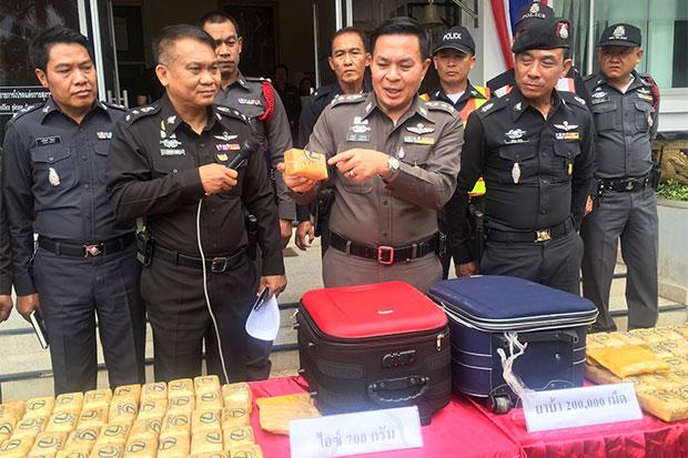 Pol Col Charan Roengtham, deputy chief of Chiang Rai police, shows a package of speed pills with the new logo during a media briefing on Thursday following a search of a Bangkok-bound tour bus in Phan.