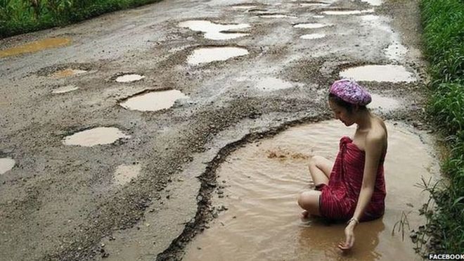 _91410196_potholes_bath_lady.jpg